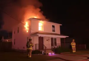 Firefighters battling a house fire in the Portland neighborhood of Louisville